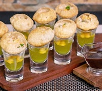 a tray of small appetizers on a wooden tray